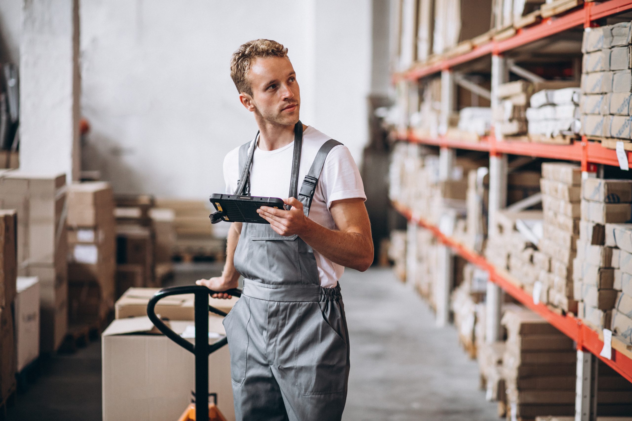 young man working at a warehouse with boxes